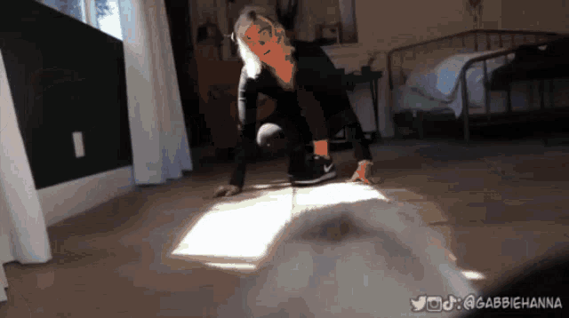 a woman is crawling on the floor in a room with a twitter account @abbiehanna