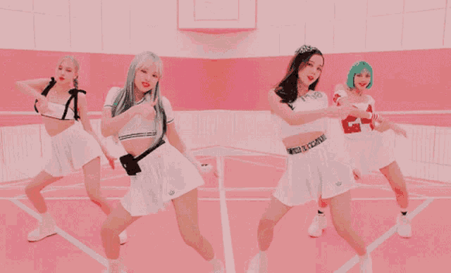a group of girls are dancing on a pink court and one of them has a number 23 on her shirt