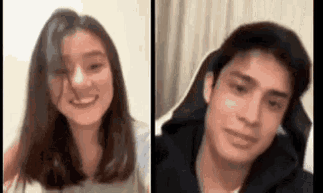 a man and a woman are sitting next to each other on a bed .