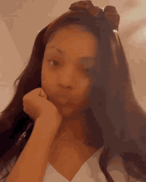 a girl with a headband on her head is making a face
