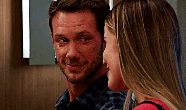 a man and a woman are looking into each other 's eyes