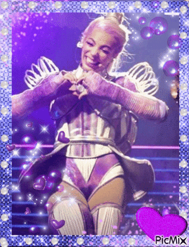 a picture of a woman making a heart with her hands and a purple heart in the corner