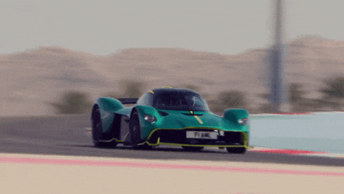 a green sports car with a license plate that says pi4l