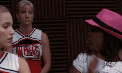 three cheerleaders wearing wmhs uniforms are talking