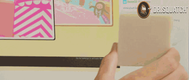 a person holding a card in front of a screen that says dr. squatch