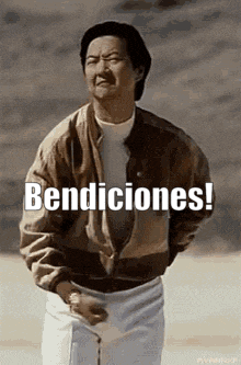 a man in a jacket is holding a golf club and says bendiciones !