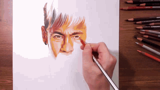 a person is drawing a man 's face with a brush