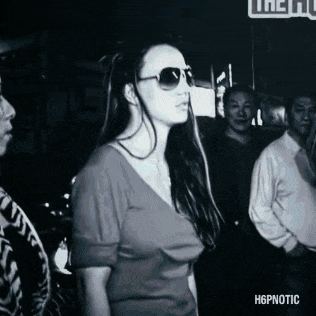 a black and white photo of a woman wearing sunglasses and a shirt that says hypnotic