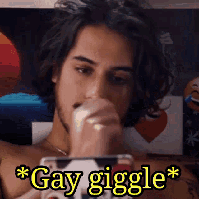 a shirtless man is looking at a cell phone with the words gay giggle above him