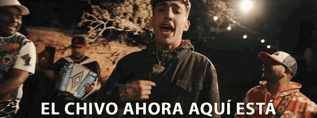 a group of men singing in spanish with the words el chivo ahora aqui esta on the bottom