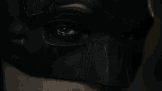 a close up of a man wearing a black mask