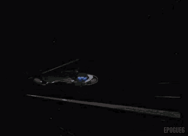 a black and white photo of a fighter jet flying in the dark .