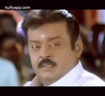 a man with a mustache is making a funny face in a movie .