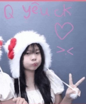 a girl wearing a white hat with a red bow on it