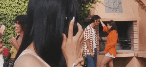 a woman is taking a picture of a man and woman