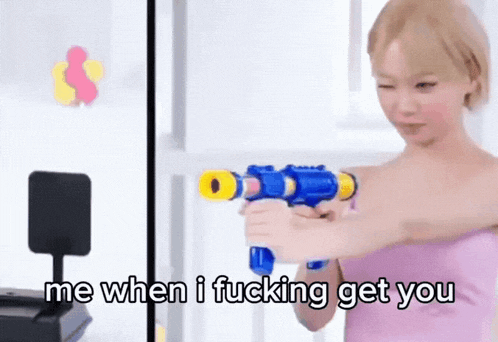 a woman in a pink dress is holding a water gun and says me when i fucking get you