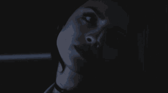 a close up of a woman 's face with a dark background