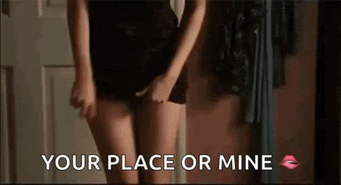 a woman in a black dress is standing in front of a mirror with the words `` your place or mine '' written on it .