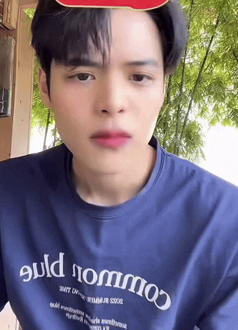 a man wearing a blue shirt that says build nommo on it