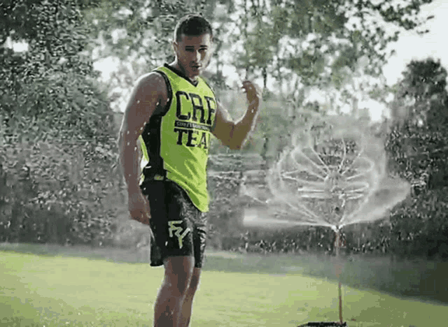 a man wearing a green tank top that says caf on it