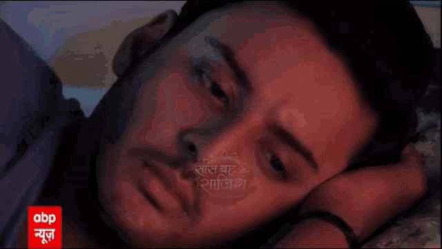 a close up of a man 's face with abp written on the bottom right