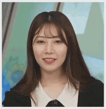 a close up of a woman wearing a black jacket and a white shirt .