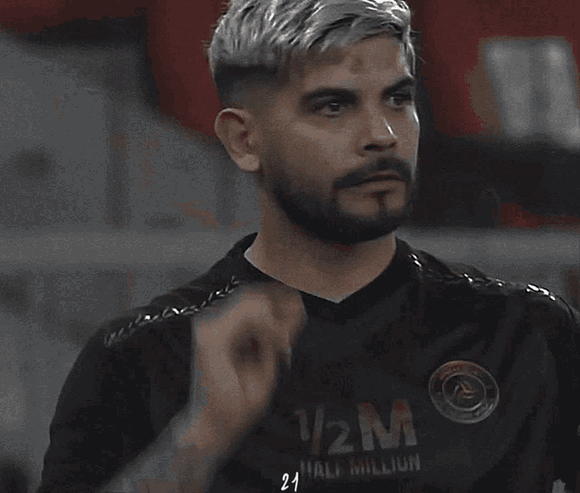 a man with a beard is wearing a black jersey with the number 21 on it