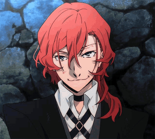 a man with red hair is wearing a black suit and a white shirt