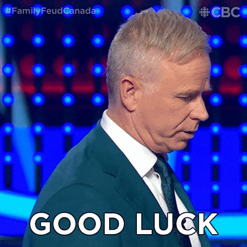 a man in a suit says good luck in front of a blue background