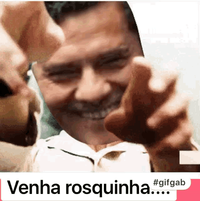 a gif of a man pointing at the camera with the words venha rosquinha