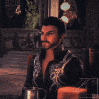 a man with a ponytail sits at a table with a mug in front of him and the name lynnerdo is visible