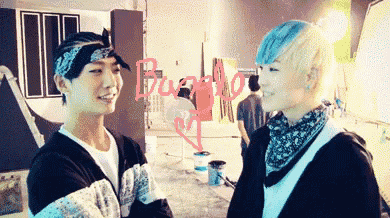 two young men are standing next to each other with the word buzz on the wall