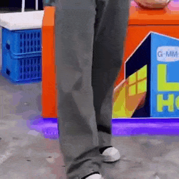 a person is standing in front of a sign that says g-mm-l-h on it .