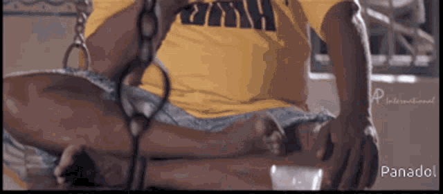 a man in a yellow shirt that says panadol