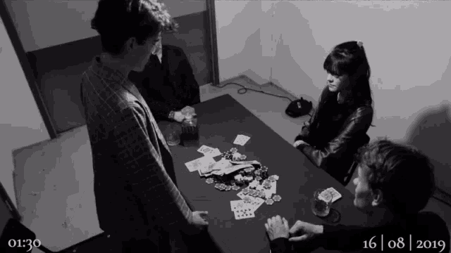 a black and white photo of people sitting around a table with the date 16 08 2019