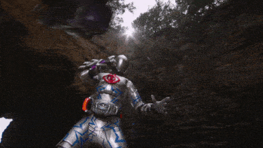 a man in a silver armor is standing in front of a cliff
