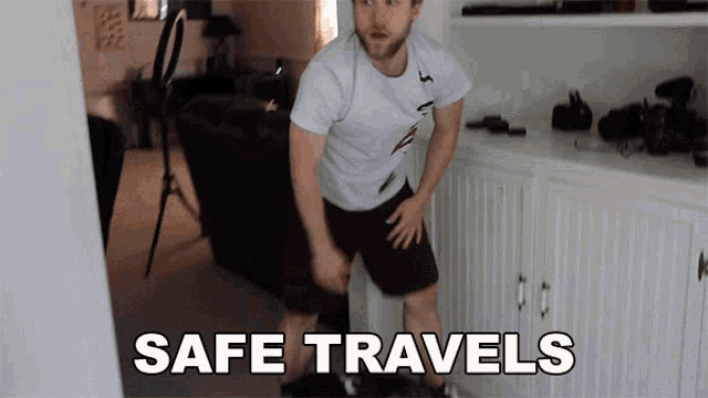 a man standing in a room with the words safe travels written on the wall