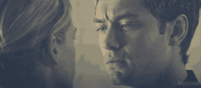 a man and a woman are looking at each other and the words happysnail are on the bottom right