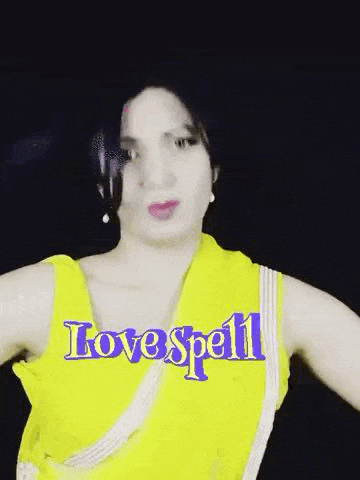a woman in a yellow dress with the words `` love spell '' written on it is dancing .