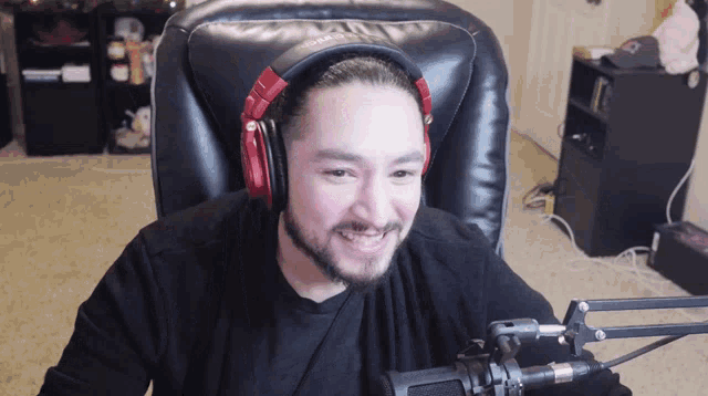 a man wearing headphones is sitting in a chair