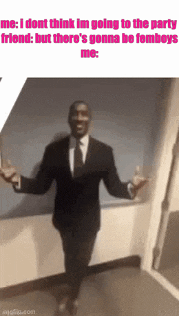 a man in a suit and tie is walking down a hallway .