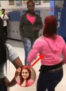 a woman in a pink hoodie is standing next to another woman in a green jacket