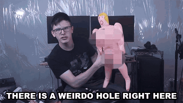 a man sitting in front of a naked doll with the words " there is a weirdo hole right here " above him