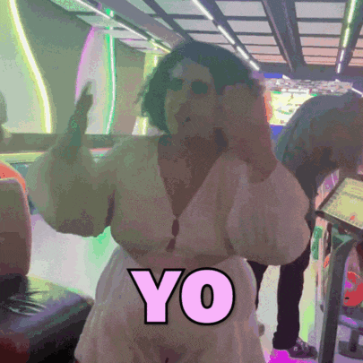 a woman in a white dress is dancing with the word yo on her chest
