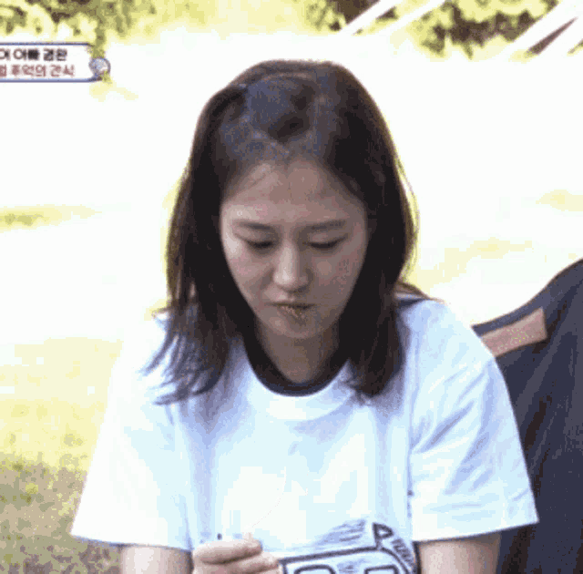 a woman wearing a white t-shirt that says ' r ' on it