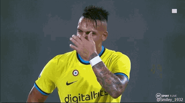 a soccer player wearing a yellow shirt with digitalbet on it