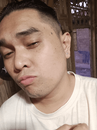 a close up of a man 's face with a y on his ear
