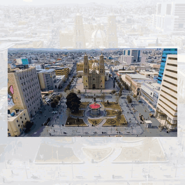 an aerial view of a city with a cathedral in the middle