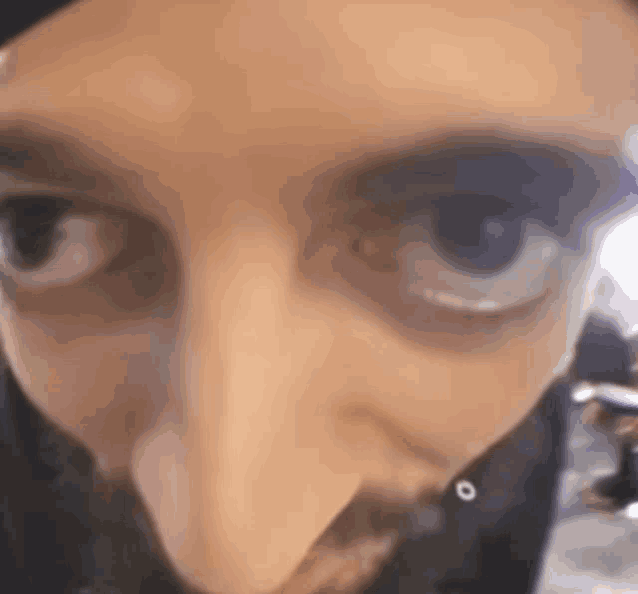 a close up of a man 's eyes with a beard