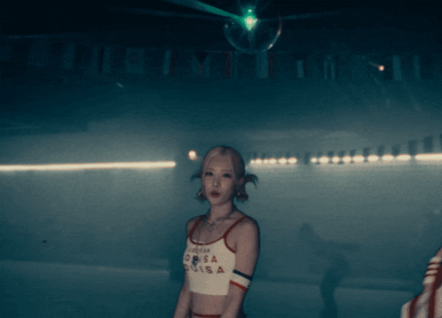 a woman is wearing a crop top that says louisa